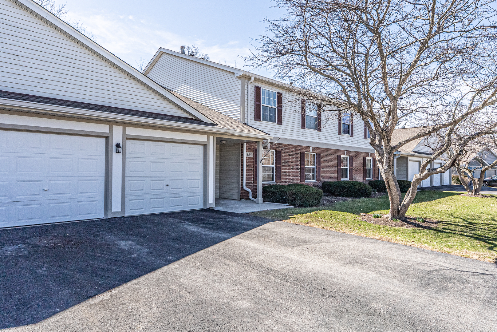 383 Woodview Circle, Unit C Elgin, IL 60120 - Photo 1 of 20 a view of a house with a yard covered in snow