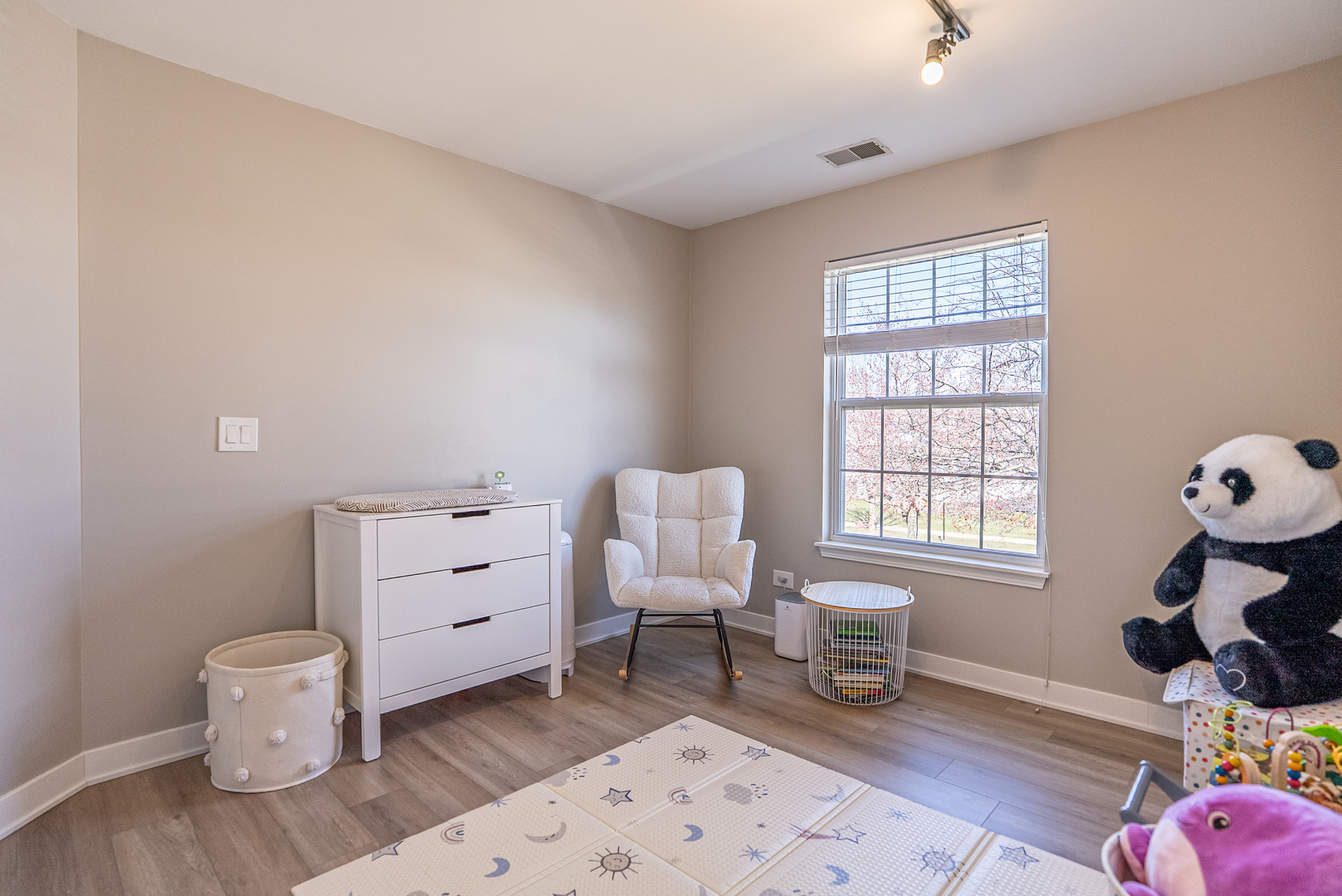 383 Woodview Circle, Unit C Elgin, IL 60120 - Photo 14 of 20 a room with a baby crib furniture and a window
