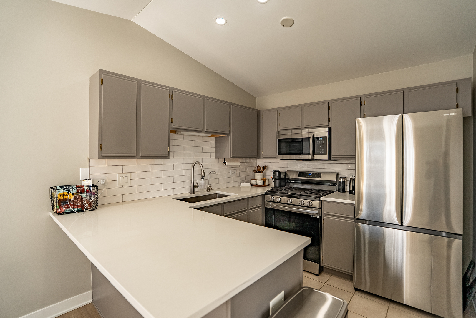 383 Woodview Circle, Unit C Elgin, IL 60120 - Photo 9 of 20 a kitchen with a refrigerator a stove a sink and white cabinets