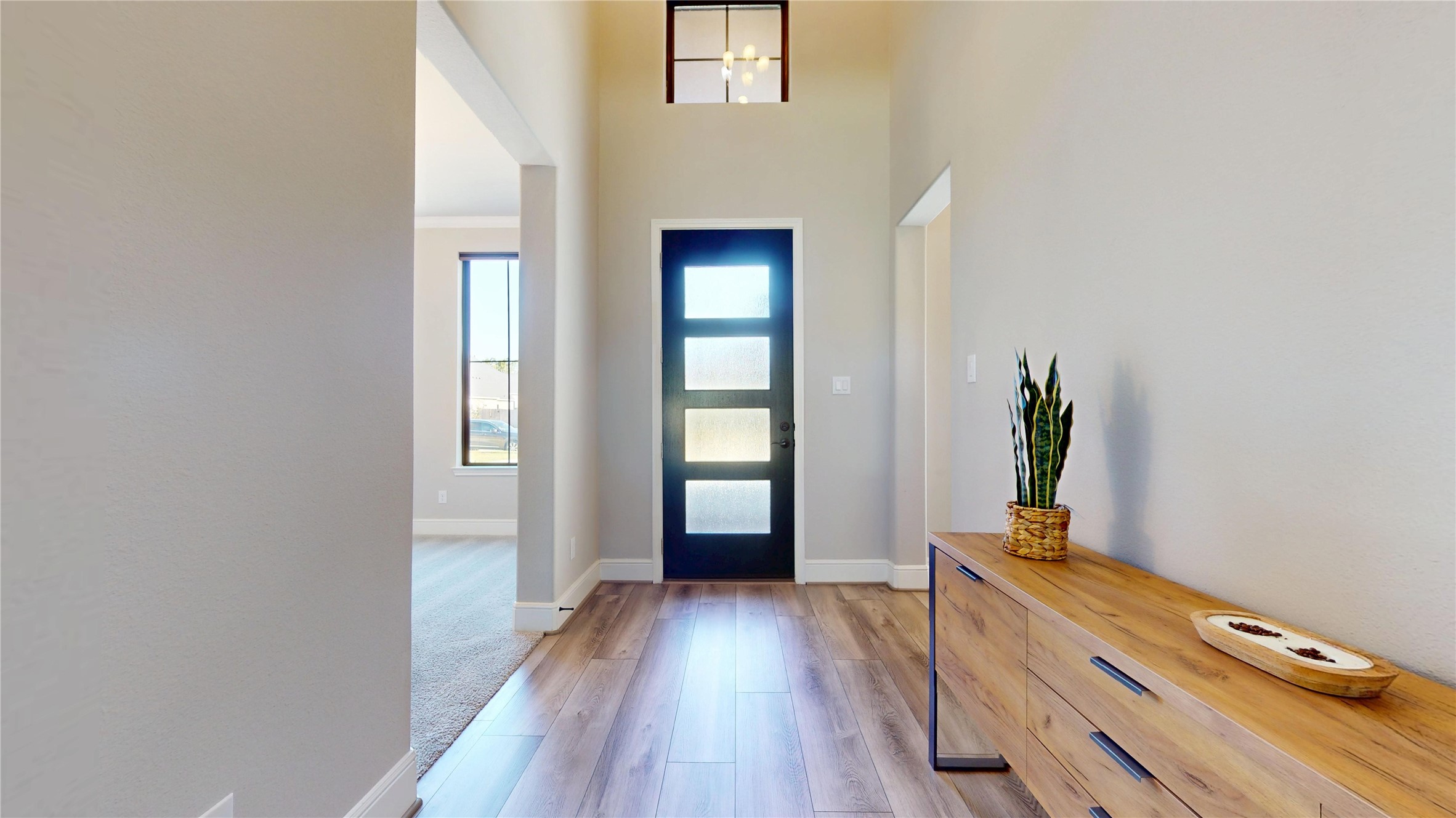 8305 Greenleaf Ridge Way Conroe, TX 77385 - Photo 3 of 33 a view of a hallway with wooden floor and a living room
