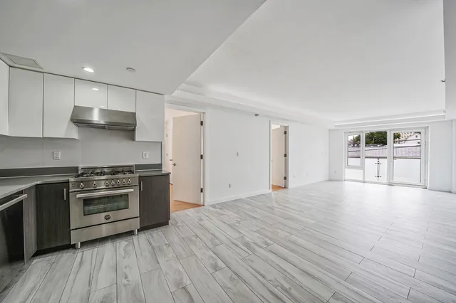 a bathroom with a granite countertop sink and a bathtub
