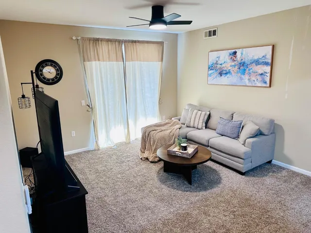 a view of a patio with a table and chairs under an umbrella