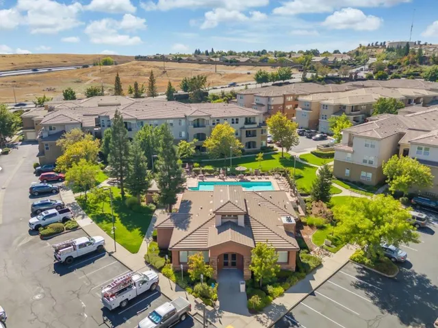 an aerial view of residential houses with outdoor space and river