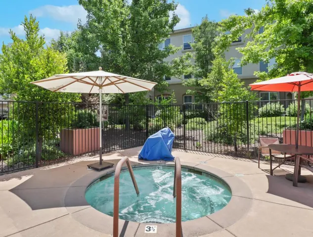 a view of a patio with a table and chairs under an umbrella