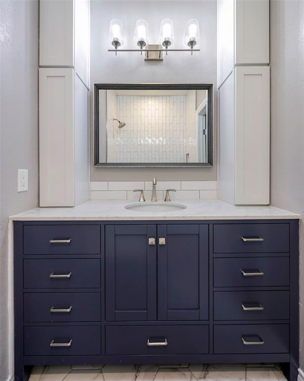 3605 Brown Street, Unit 106 Dallas, TX 75219 - Photo 11 of 19 a bathroom with a sink vanity and a mirror