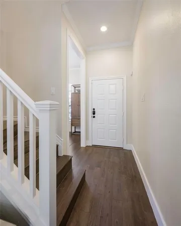 a view of entryway and hall with wooden floor