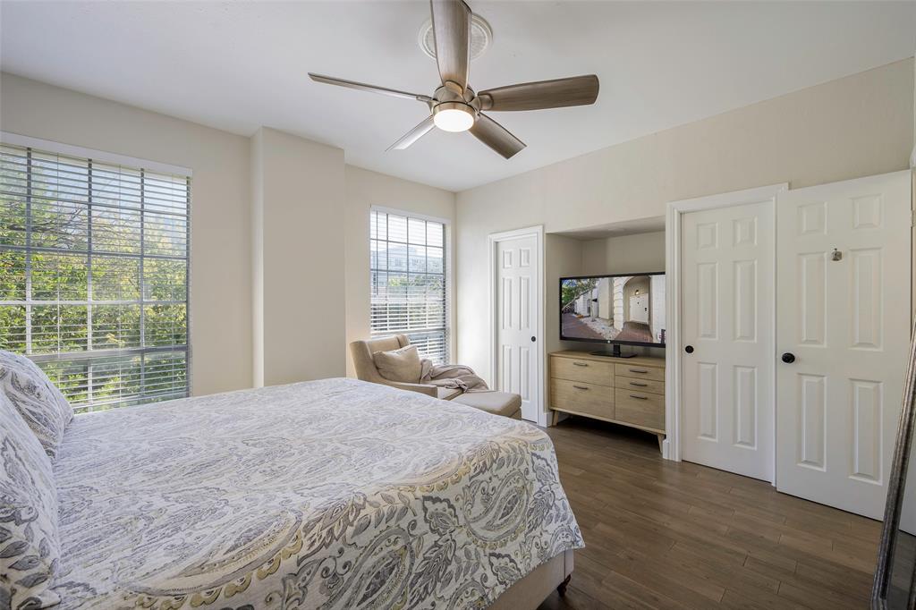 3605 Brown Street, Unit 106 Dallas, TX 75219 - Photo 10 of 19 a bedroom with a bed a large window and flat screen tv