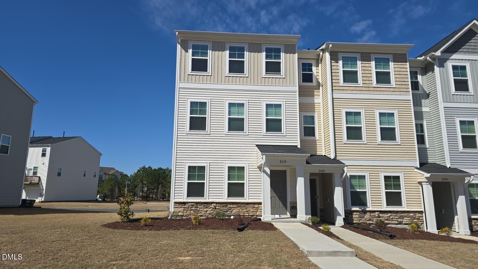 a backyard of a house with yard and parking