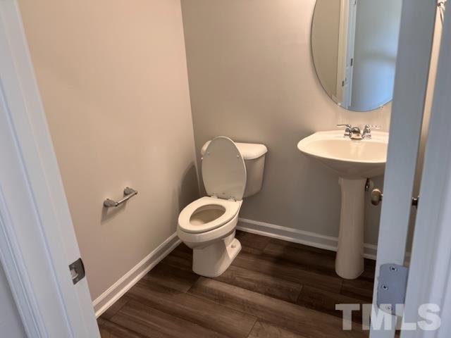 2610 Chert Lane Raleigh, NC 27610 - Photo 11 of 32 a bathroom with a toilet sink and mirror