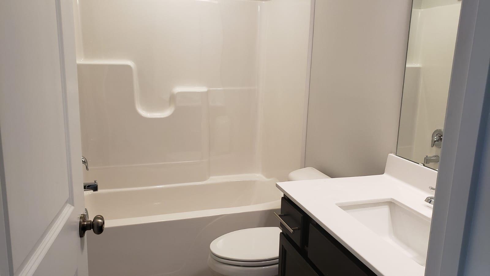 2610 Chert Lane Raleigh, NC 27610 - Photo 6 of 32 a bathroom with a sink a toilet and shower