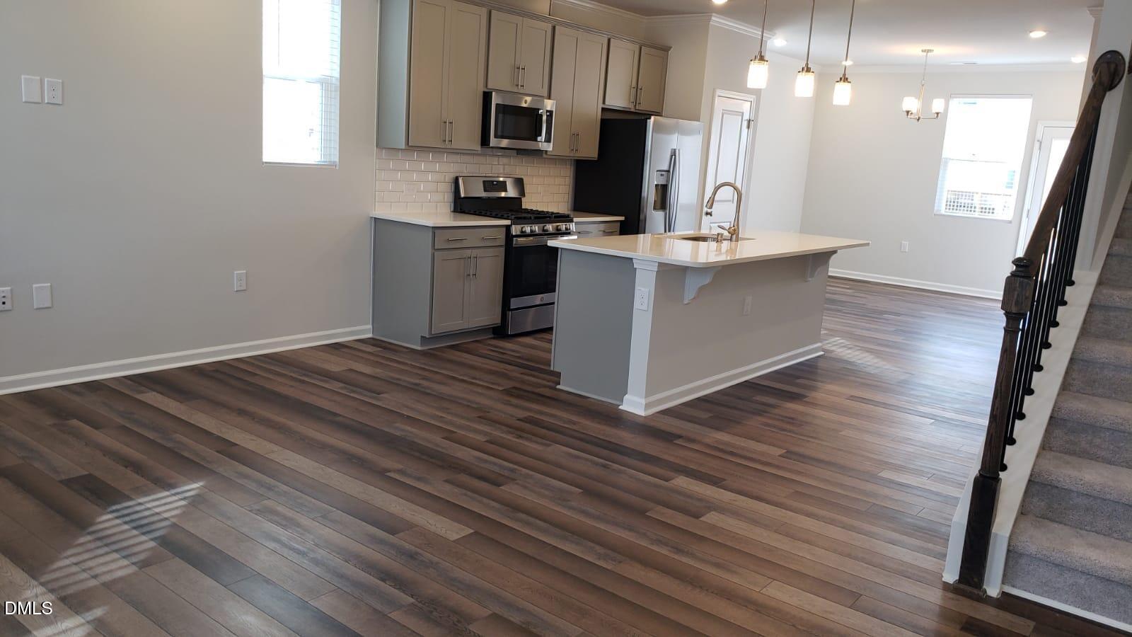 2610 Chert Lane Raleigh, NC 27610 - Photo 8 of 32 a kitchen with stainless steel appliances a refrigerator sink and microwave