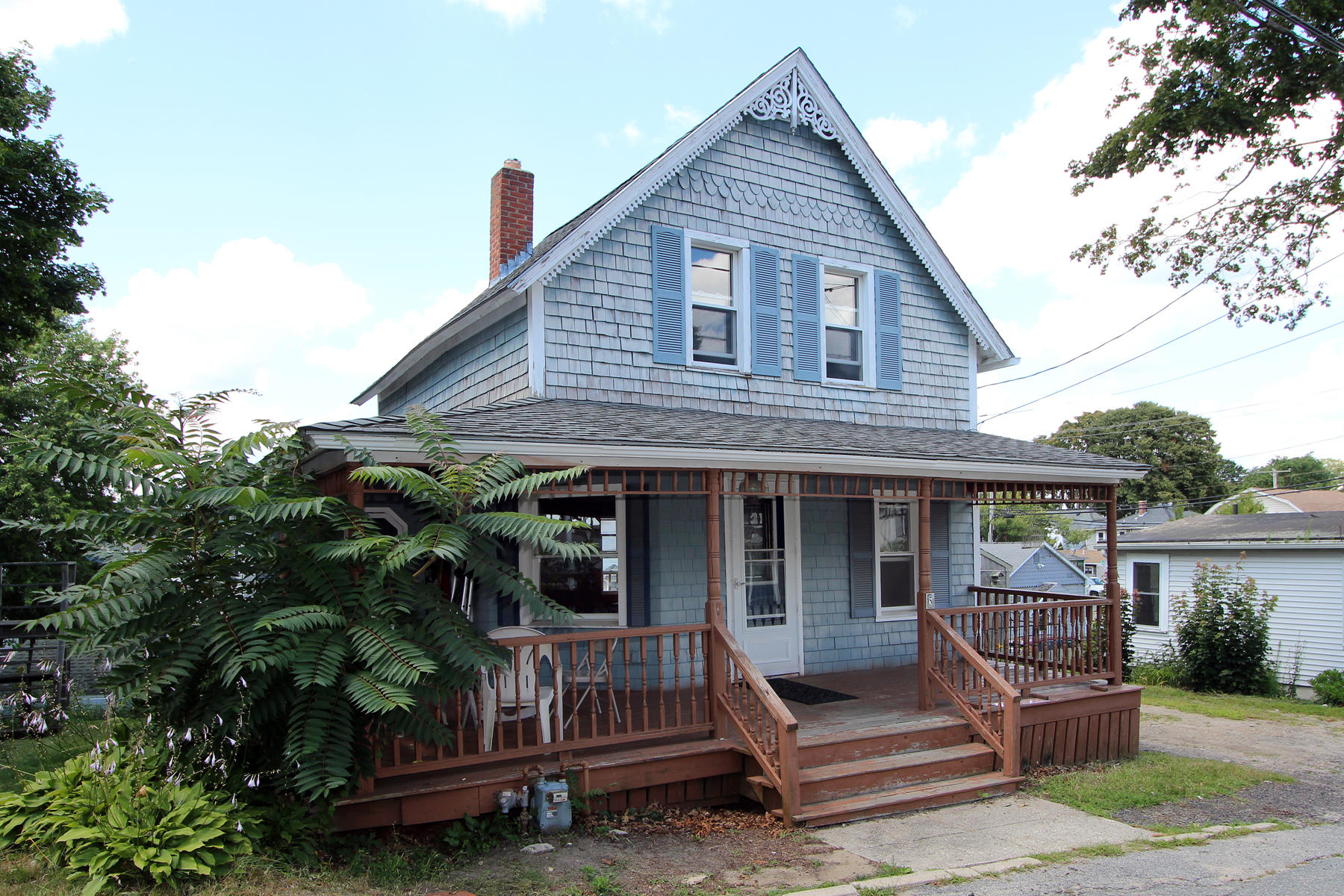 a view of a house with a yard and sitting area