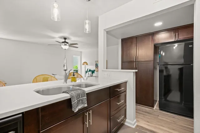 a kitchen with kitchen island a sink stainless steel appliances and cabinets
