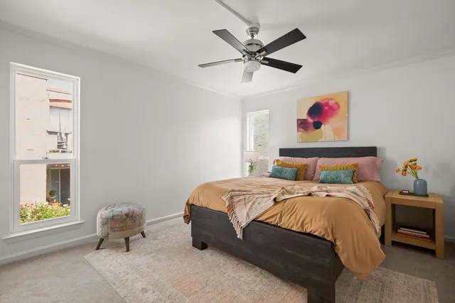 a bedroom with a bed and a chandelier