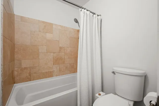 a bathroom with a toilet and a bathtub