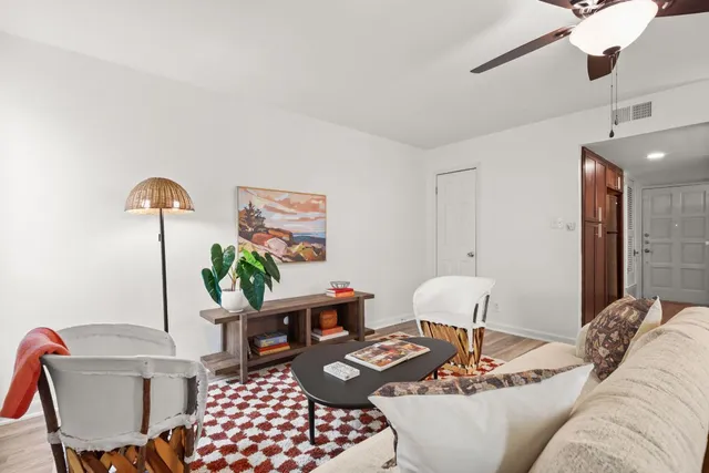 a living room with furniture and wooden floor