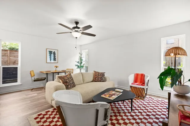 a living room with furniture and a potted plant