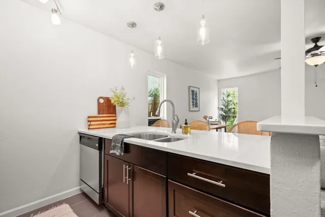 a kitchen with a sink cabinets and window