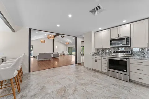 a large kitchen with cabinets and stainless steel appliances