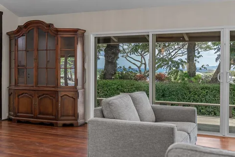 a living room with furniture and large windows