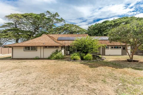 a view of a house with a backyard