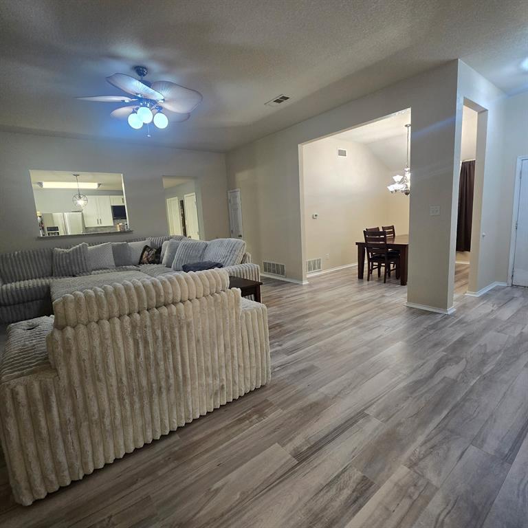 212 Druse Lane Jarrell, TX 76537 - Photo 19 of 38 a living room with furniture and a chandelier