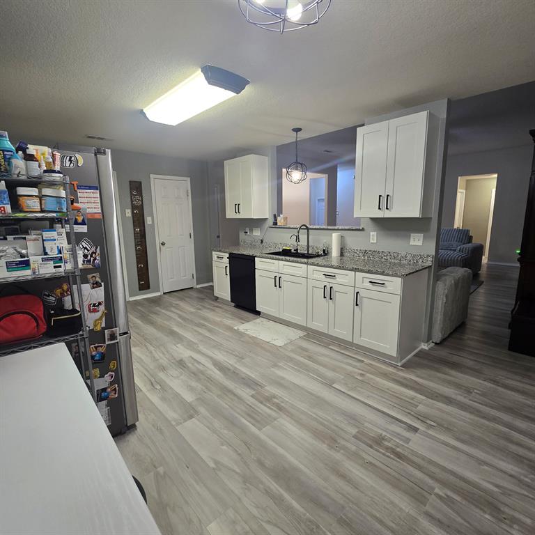 212 Druse Lane Jarrell, TX 76537 - Photo 23 of 38 a large kitchen with stainless steel appliances granite countertop a lot of counter space and wooden floor