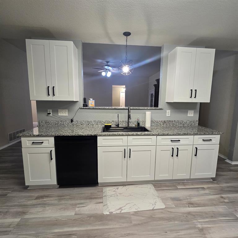 212 Druse Lane Jarrell, TX 76537 - Photo 24 of 38 a kitchen with granite countertop white cabinets and white appliances