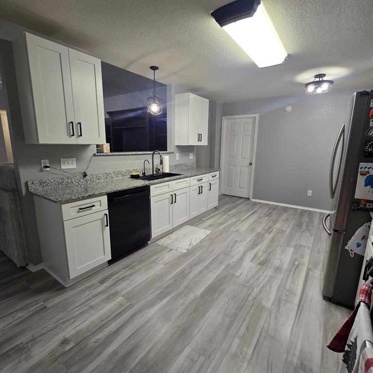 212 Druse Lane Jarrell, TX 76537 - Photo 26 of 38 a kitchen with a sink a refrigerator and cabinets