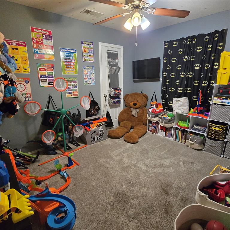 212 Druse Lane Jarrell, TX 76537 - Photo 32 of 38 a bedroom with furniture and a flat screen tv