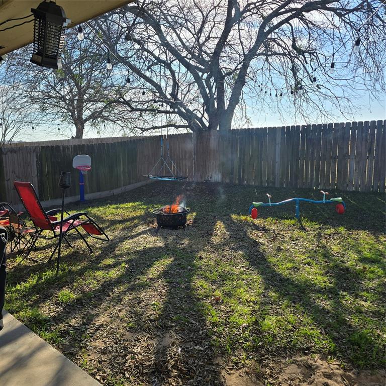 212 Druse Lane Jarrell, TX 76537 - Photo 33 of 38 a backyard of a house with table and chairs