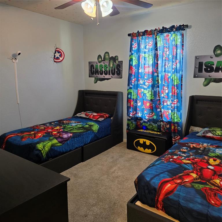 212 Druse Lane Jarrell, TX 76537 - Photo 34 of 38 a bedroom with a bed window and two lamp on dresser