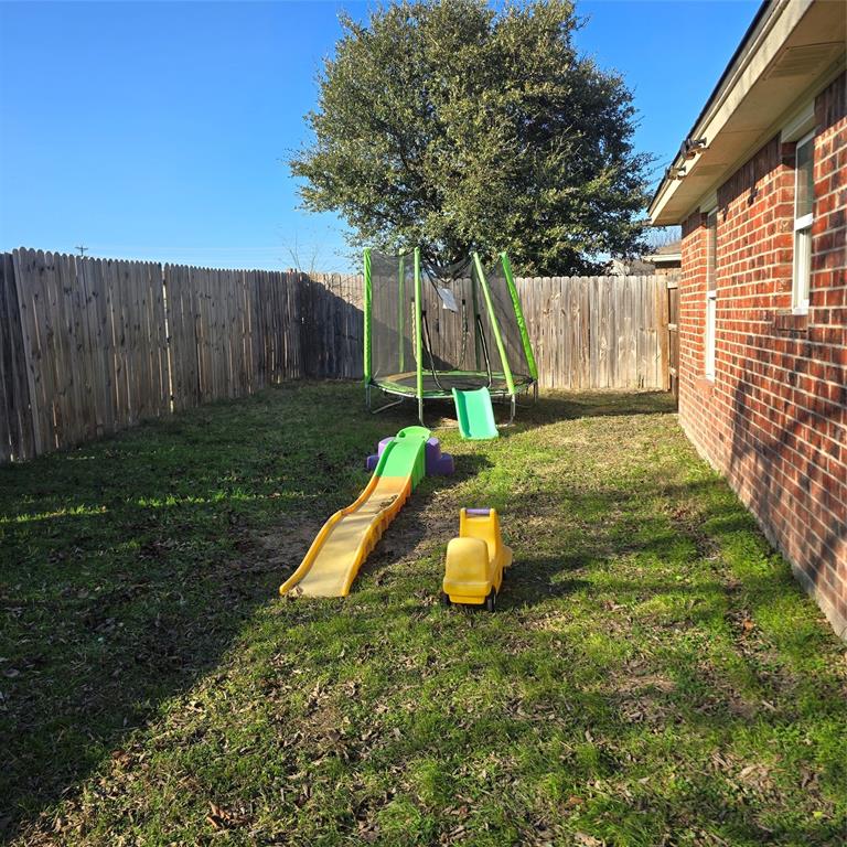 212 Druse Lane Jarrell, TX 76537 - Photo 35 of 38 a view of a backyard with table and chairs and wooden fence