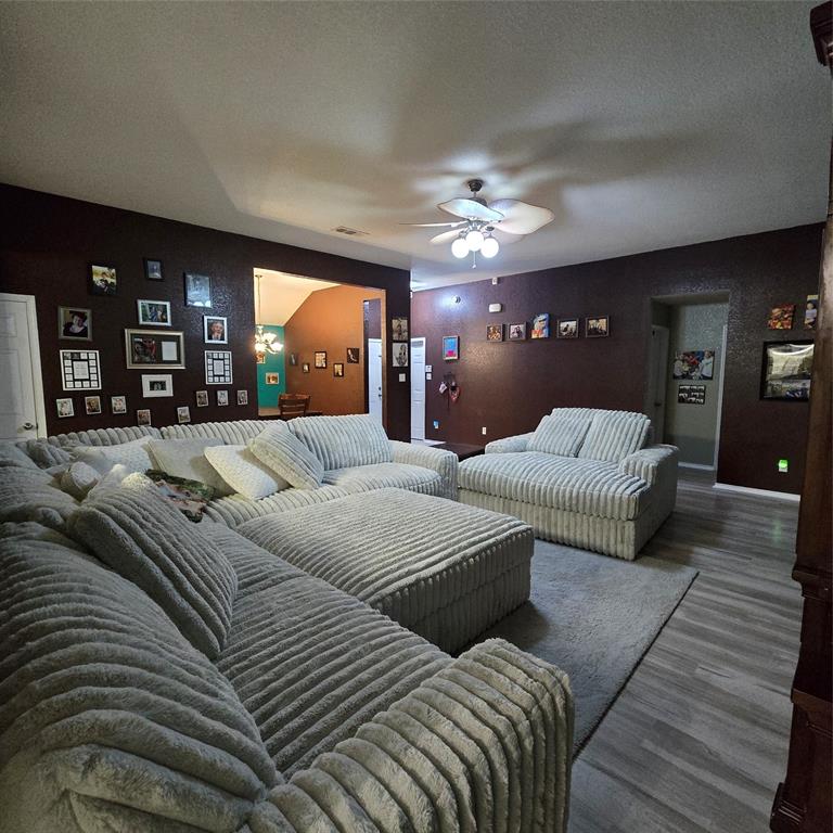 212 Druse Lane Jarrell, TX 76537 - Photo 4 of 24 a large bedroom with a large bed and a chandelier