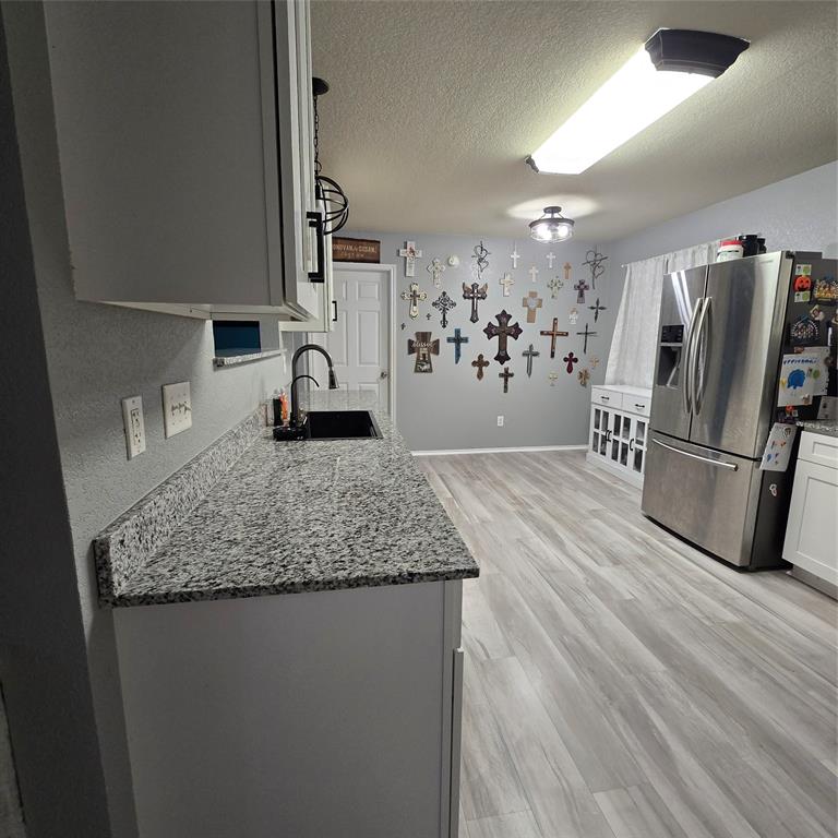 212 Druse Lane Jarrell, TX 76537 - Photo 6 of 38 a kitchen with kitchen island a counter top space a sink and stainless steel appliances