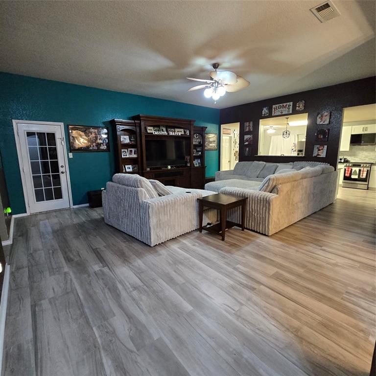 212 Druse Lane Jarrell, TX 76537 - Photo 7 of 24 a living room with furniture and a chandelier