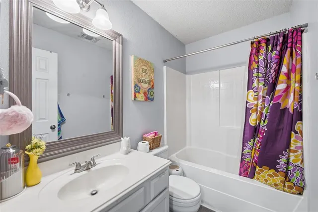 a view of a bedroom with a bed and wooden floor