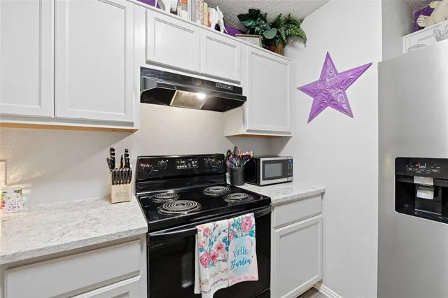 a kitchen with refrigerator a sink and cabinets