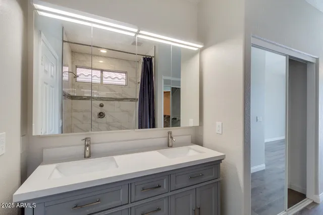 a bathroom with a sink and a mirror
