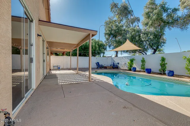 a view of patio with a table and chairs under an umbrella