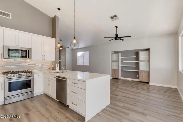 a kitchen with a stove and a wooden floors