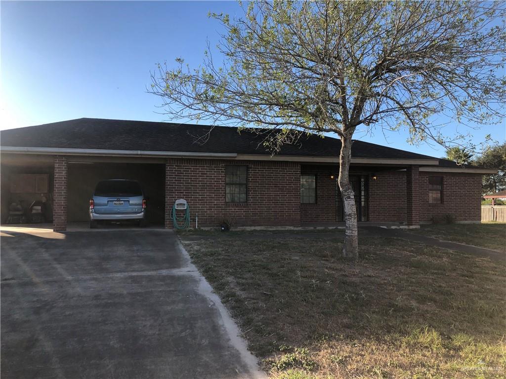 8820 East Rogers Road Edinburg, TX 78542 - Photo 1 of 1 a front view of a house with a yard and garage
