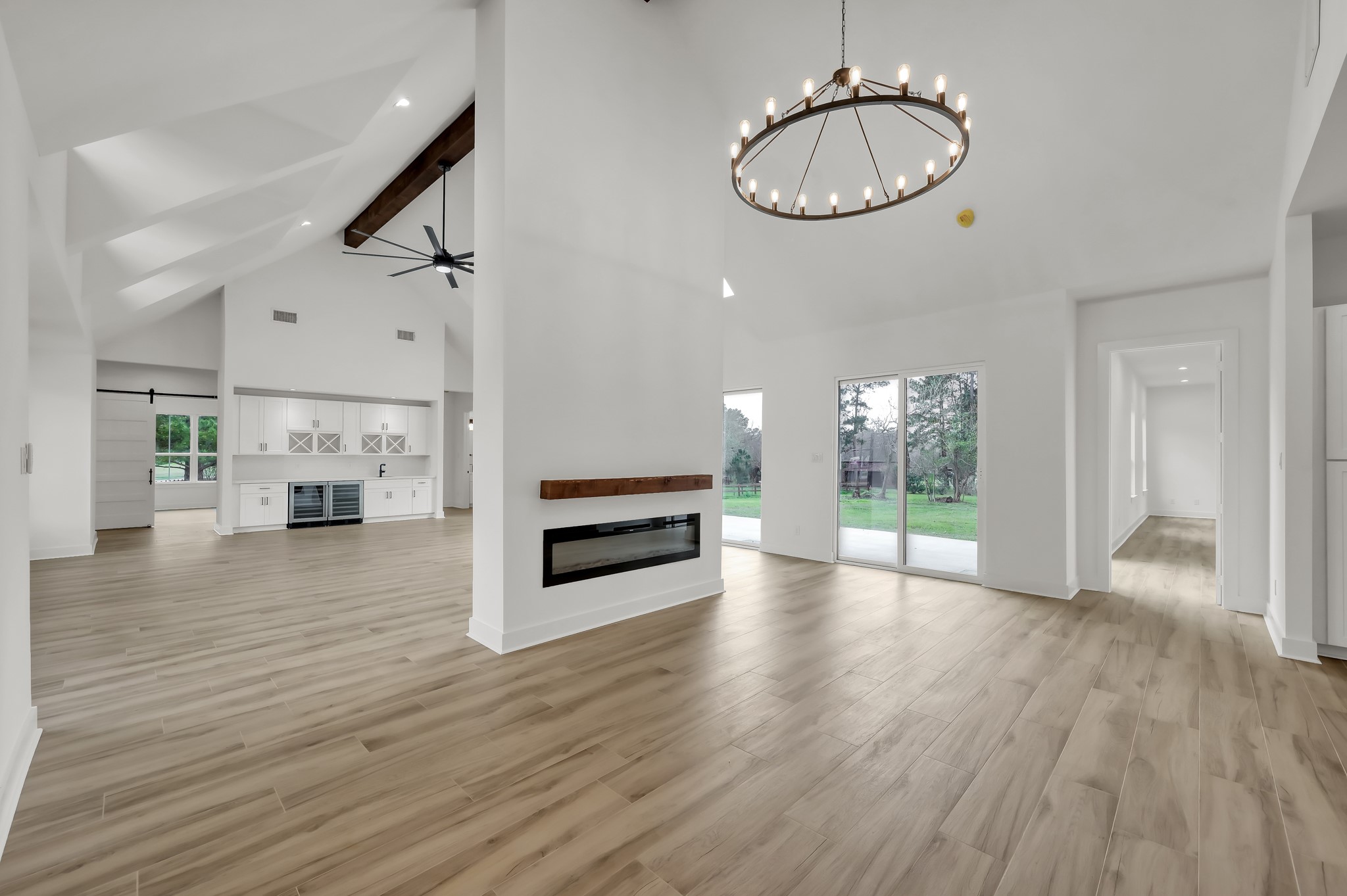 14742 Turquoise Trail Willis, TX 77378 - Photo 13 of 48 Another view of the dining room and living area emphasizing the dramatic vaulted ceilings and the sleek double-sided fireplace that anchors the room.