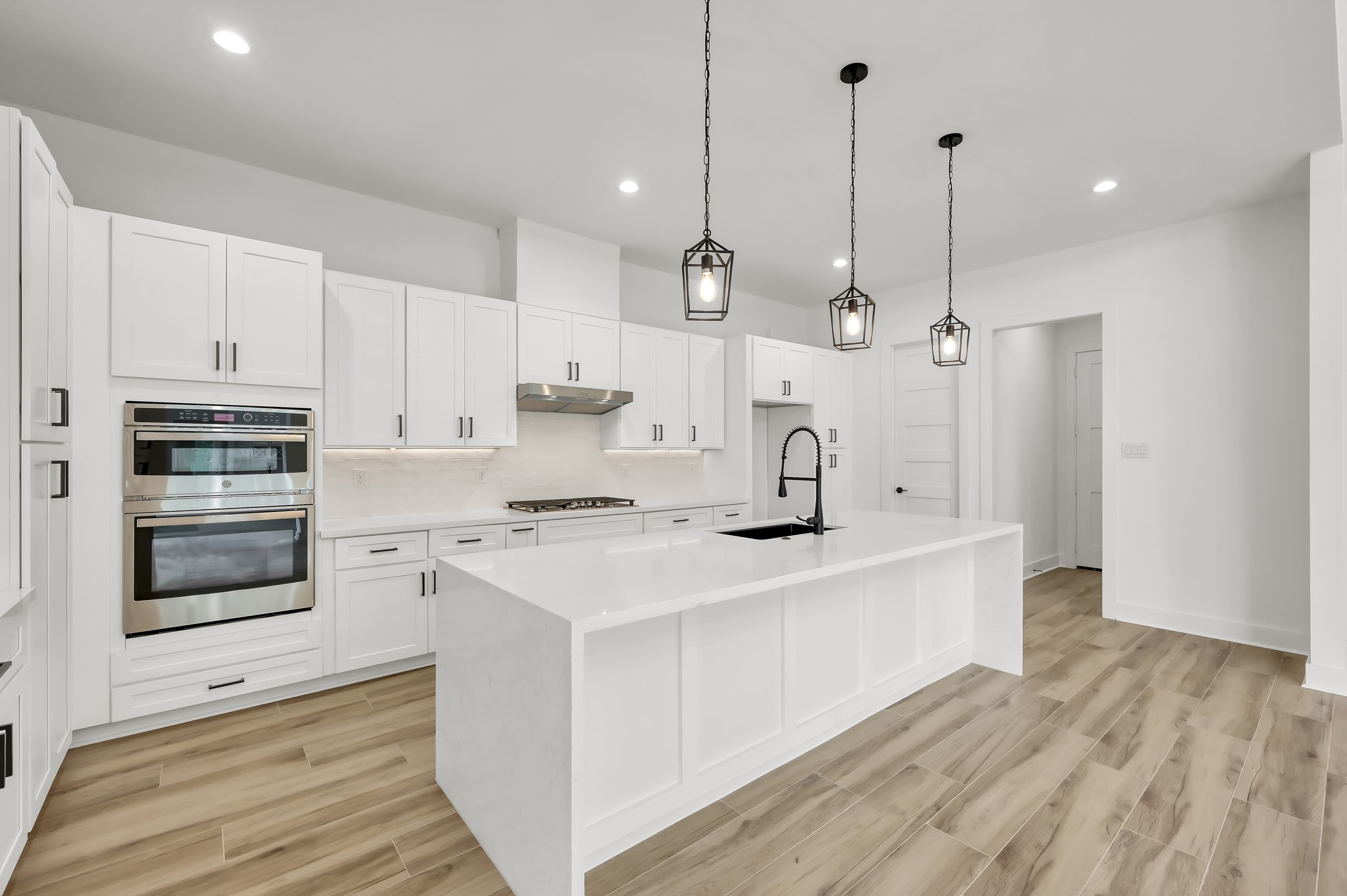 14742 Turquoise Trail Willis, TX 77378 - Photo 18 of 48 a kitchen with stainless steel appliances a stove a sink and white cabinets