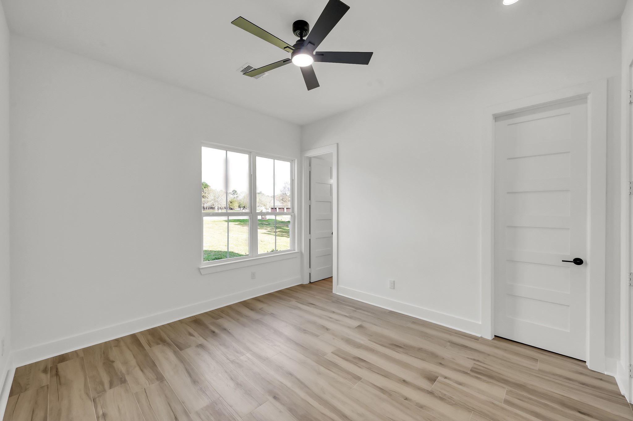 14742 Turquoise Trail Willis, TX 77378 - Photo 29 of 48 wooden floor in an empty room with a window