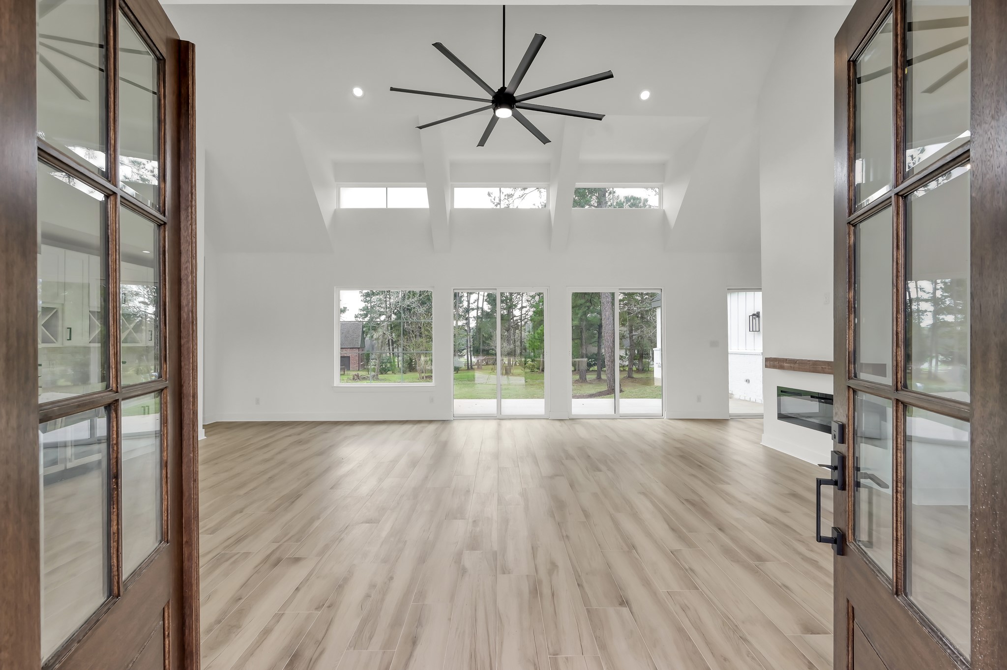 14742 Turquoise Trail Willis, TX 77378 - Photo 4 of 48 The impressive entry welcomes you into a spacious living area with cathedral ceilings, wood-look flooring, and abundant natural light.