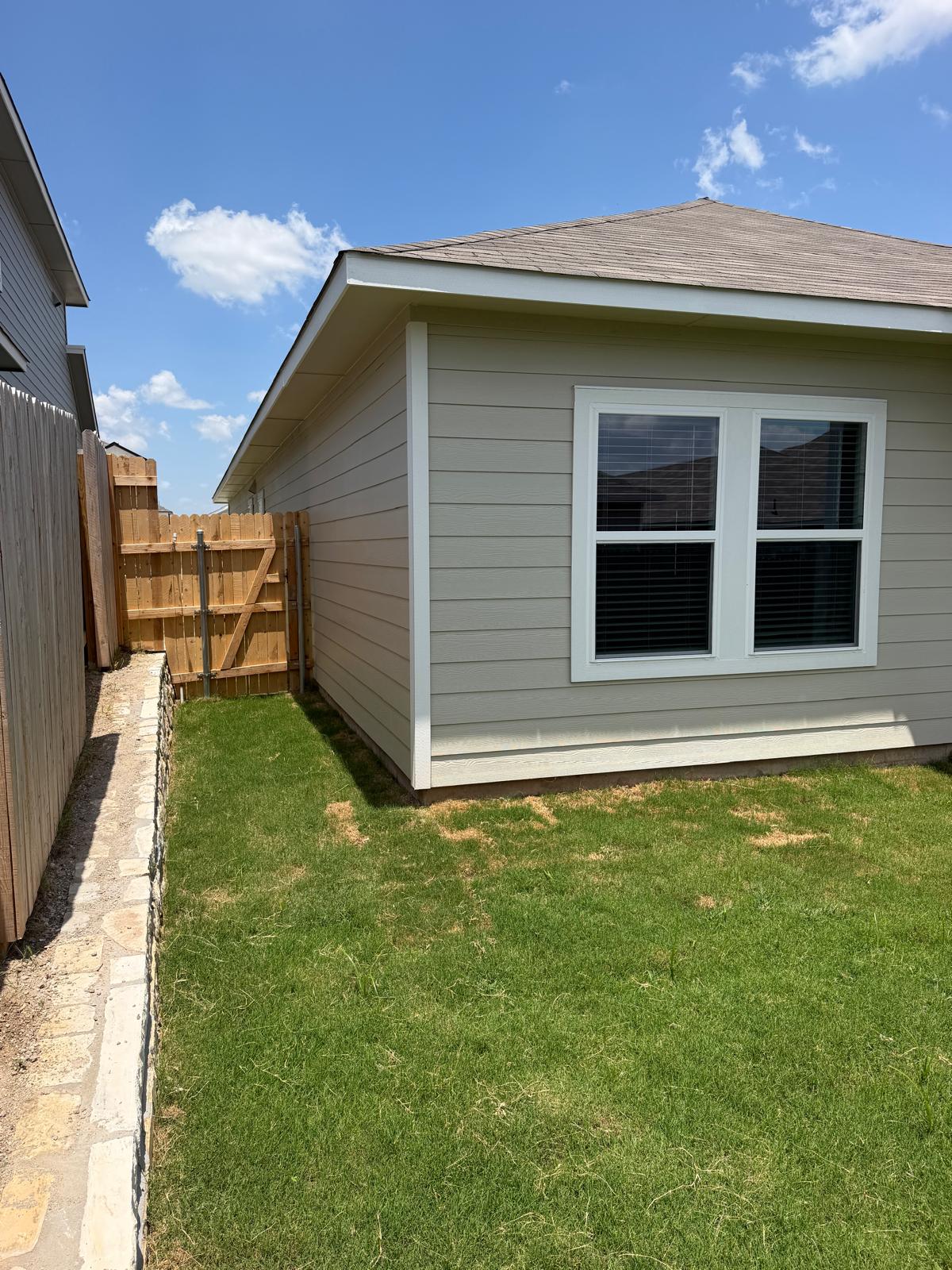 2701 Towy Road Manor, TX 78653 - Photo 30 of 35 A neatly maintained lawn and fenced perimeter define this home's private outdoor space.