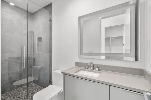 a bathroom with a sink toilet and shower