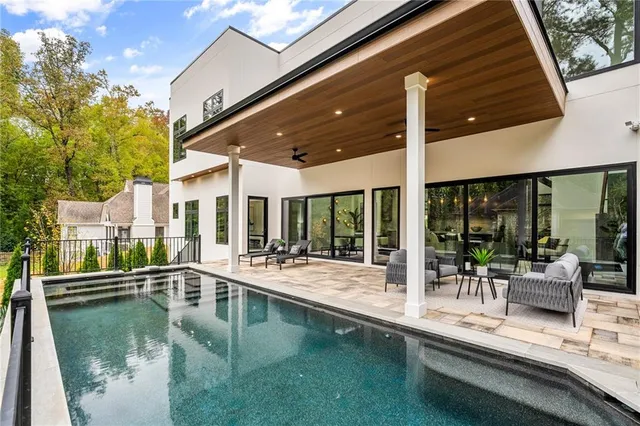 a view of a patio with swimming pool table and chairs