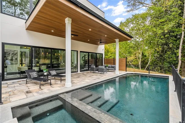 a swimming pool with outdoor seating and yard